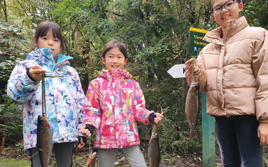 Children show off their trout caught in the children's fishing pond near Turangi