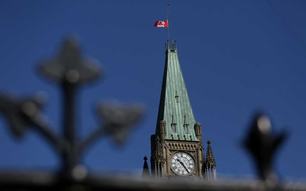 A Canadian flag flies at half-mast on top of the Peace Tower to mourn the victims of the of the Nova Scotia shooting April 20, 2020 in Ottawa, Canada.