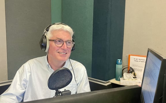 RNZ Nights host Mark Leishman speaks into the microphone while presenting the show.