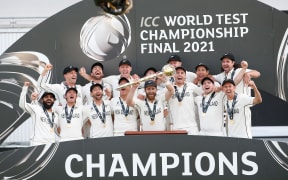 Kane Williamson the New Zealand Blackcaps captain lifts the World Test Championship Mace surrounded by teammates at Southampton, England on Saturday 23rd June 2021.