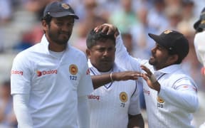 Rangana Herath celebrates with teamates after taking a wicket in a test against England at Lord's.