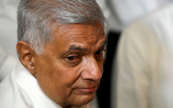 (FILES) In this file photo taken on May 12, 2022, Sri Lanka's new prime minister Ranil Wickremesinghe visits a Buddhist temple after his swearing in ceremony in Colombo. - The 73-year-old Wickremesinghe will automatically become acting president in the event of Gotabaya Rajapaksa's resignation, but has himself announced his willingness to step down if consensus is reached on forming a unity government. (Photo by Ishara S. KODIKARA / AFP)