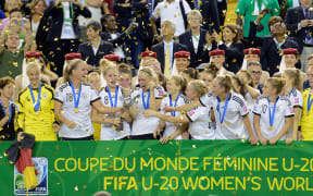 Germany celebrates with the championship trophy during the FIFA Women's U-20 Final at Olympic Stadium in 2014 in Canada. Germany defeated Nigeria 1-0 in overtime