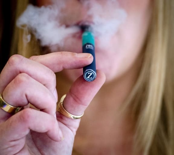 A woman smoking an electronic cigarette