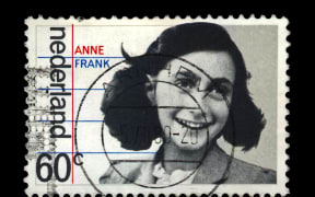 NETHERLANDS - CIRCA 1980: canceled postal stamp printed in the Netherlands shows Anne Frank, 35th anniversary of liberation from the Germans, circa 1980. Vintage stamp isolated on black background.
