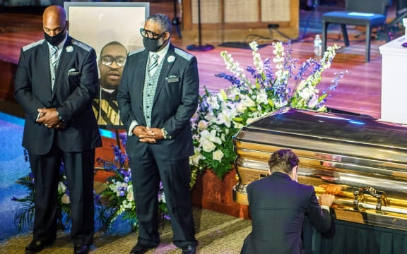 Minneapolis Mayor Jacob Frey, right,  pays his respects at the memorial service for George Floyd in Minneapolis, Minnesota.