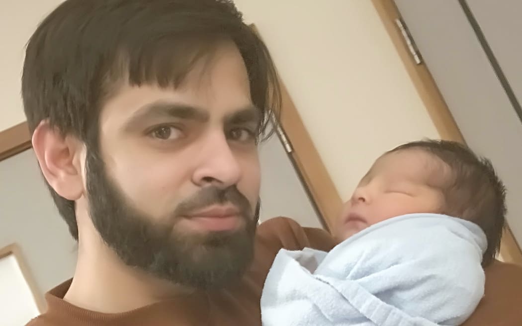 Syed Jahandad Ali holding son Mohammad Yousuf Ali.