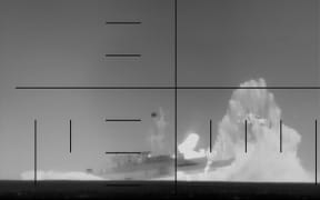 This frame grab from a video released by the US Department of Defense on March 4, 2026, shows what the Department of Defense says is periscope footage of a US Navy submarine firing on and sinking an Iranian warship in the Indian Ocean. A US submarine torpedoed and sank an Iranian warship in the Indian Ocean, Defense Secretary Pete Hegseth said Wednesday. Nearly 150 were missing and several dead after the frigate IRIS Dena sank Wednesday off Sri Lanka, officials said. (Photo by US Department of Defense / AFP) / RESTRICTED TO EDITORIAL USE - MANDATORY CREDIT "AFP PHOTO /  US DEPARTMENT OF DEFENSE / HANDOUT" - HANDOUT - NO MARKETING NO ADVERTISING CAMPAIGNS - DISTRIBUTED AS A SERVICE TO CLIENTS