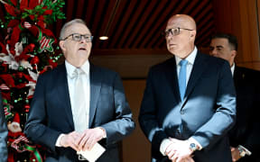 Australia's Prime Minister Anthony Albanese (L) talks with Australia's Opposition Leader Peter Dutton at the Wishing Tree at Parliament House in Canberra on November 6, 2024. (Photo by TRACEY NEARMY / AFP)