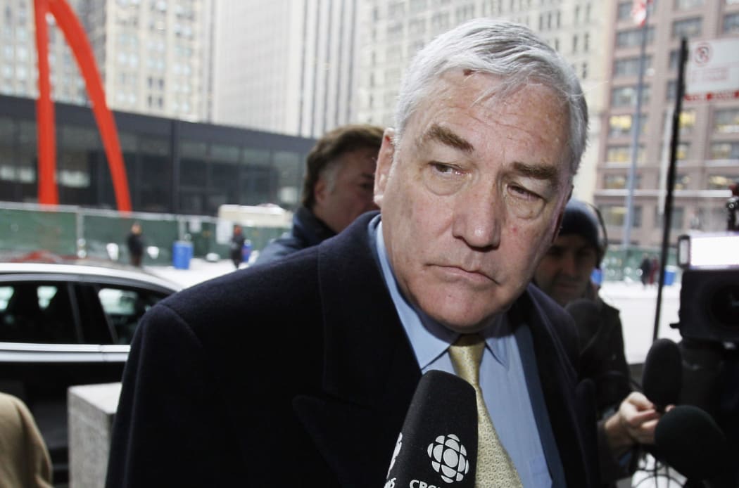 FILE - In this Jan. 13, 2011 file photo, Conrad Black arrives at the federal building in Chicago. President Donald Trump has granted a full pardon to Black, a former newspaper publisher who has written a flattering political biography of Trump.