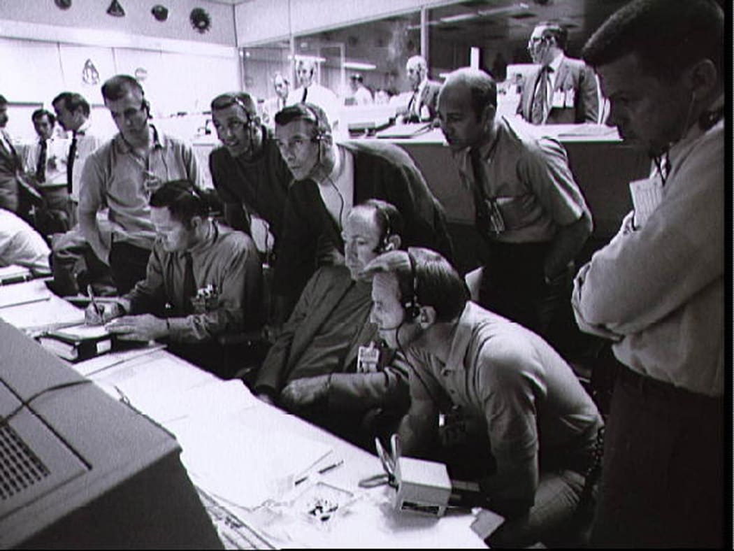A group of eight astronauts and flight controllers monitor the console activity in the Mission Operations Control Room during the Apollo 13 lunar landing mission in this 14 April 1970 file photo.