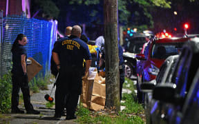 Police place a rifle in a bag on the scene of a shooting on July 3, 2023 in Philadelphia, Pennsylvania. Early reports say the suspect is in custody after shooting 6 people in the Kingsessing section of Philadelphia on July 3rd.