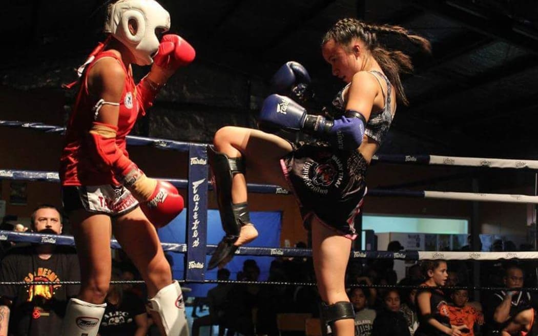 Emma Nesbitt, right, competing in Muay Thai kickboxing.