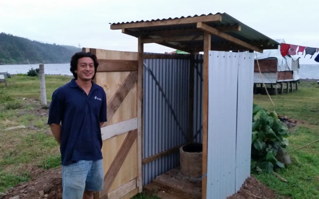 All Hands volunteer Ryan Cuevas with one of the new latrines.