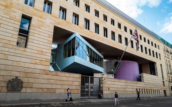 Pedestrians pass in front of the British Embassy in Berlin on August 11, 2021.