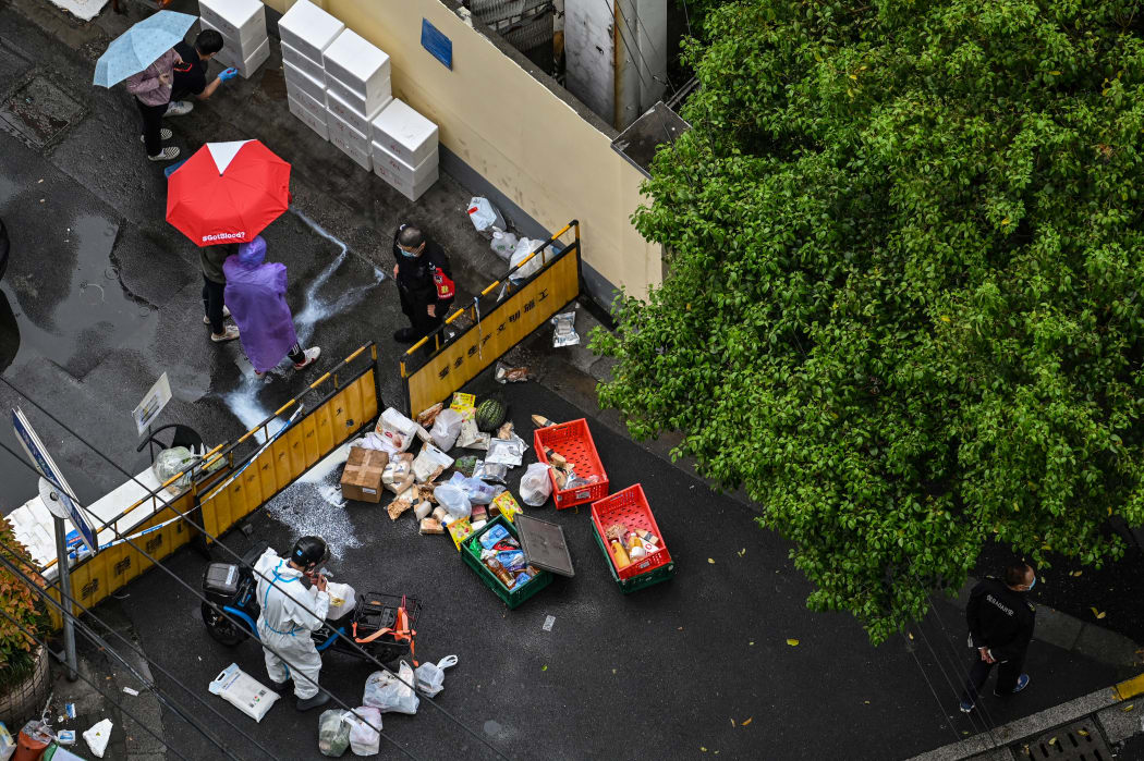 People at a street checkpoint in the Jing'an district of Shanghai during lockdown.