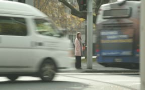 RNZ reporter Louise Ternouth crosses the road in Auckland's CBD.