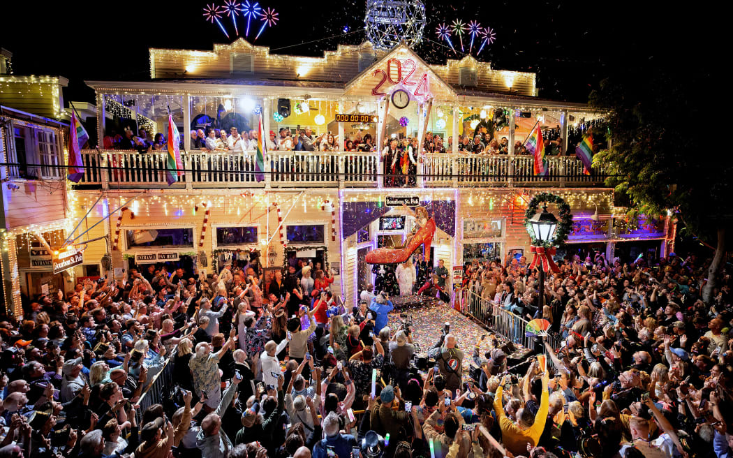 Drag Queen Christopher Peterson, the new star of the New Year's Eve "Red Shoe Drop," is lowered in a gigantic replica of a red high heel on 31 December, 2023, at the Bourbon Street Pub Complex in Key West, Florida.