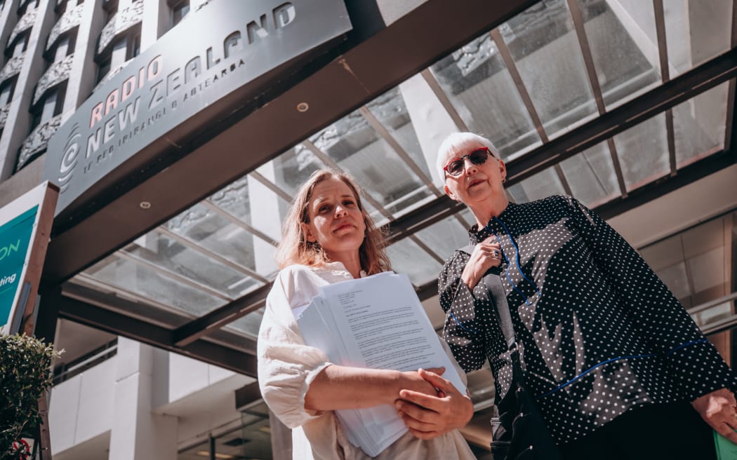 Margaret Guldborg and Elizabeth Kerr deliver a 26,000 signature petition to RNZ house in Wellington calling for a halt to proposed redundancies at RNZ Concert