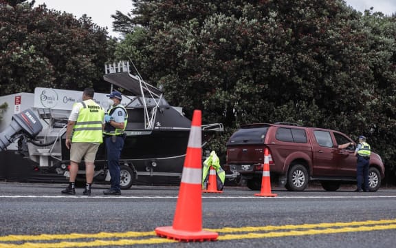 Police with iwi support at a checkpoint on SH1 at Uretiti. It is one of two new short-term checkpoints for northbound traffic set up as the Auckland region boundary opened.