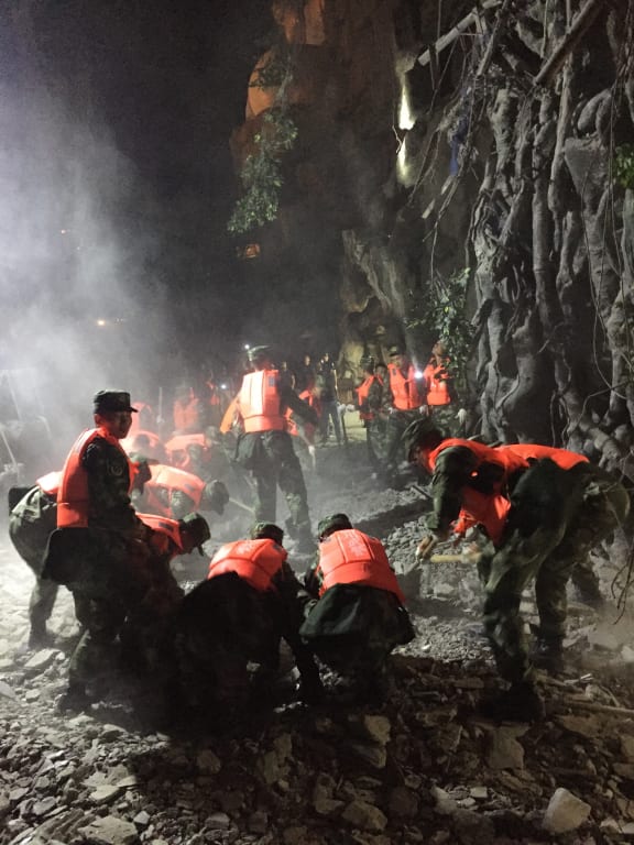 Rescuers search through rubble in the town of Jiuzhaigou after a 6.5-magnitude earthquake struck Sichuan province, China