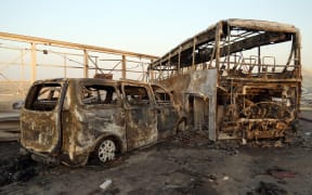 A general view show burnt out vehicles after gunmen and suicide car bombers killed dozens of people in two assaults claimed by Islamic State (IS) group jihadists near the southern Iraqi city of Nasiriyah on September 14, 2017.