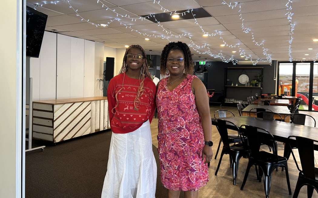 Photo of two women, smiling at the camera.