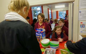 Breakfast club queue: Pupils at Stoke School line up for breakfast, provided free with the help of sponsorship and volunteers.