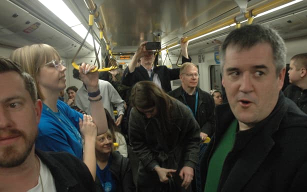 Chris Bishop in a crowded train carriage on the opening day of the CRL.
