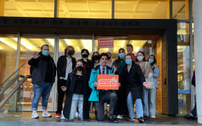 Make it 16 campaign members standing outside of the Supreme Court in Auckland after pleading their case.