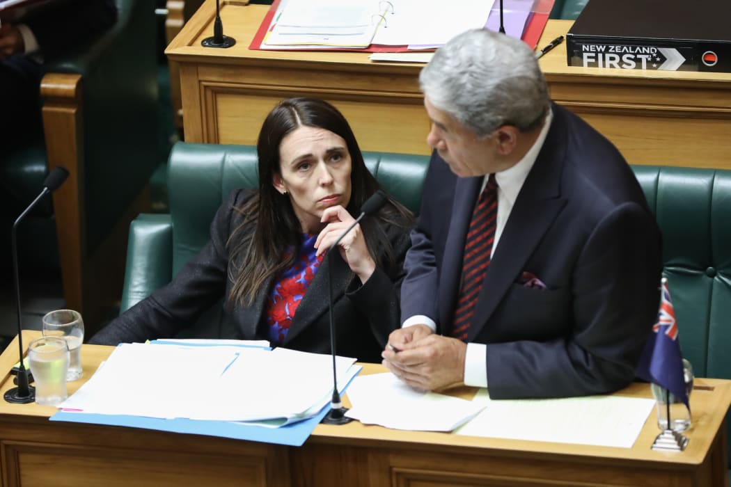 Jacinda Ardern listening to Winston Peters asking a supplementary question