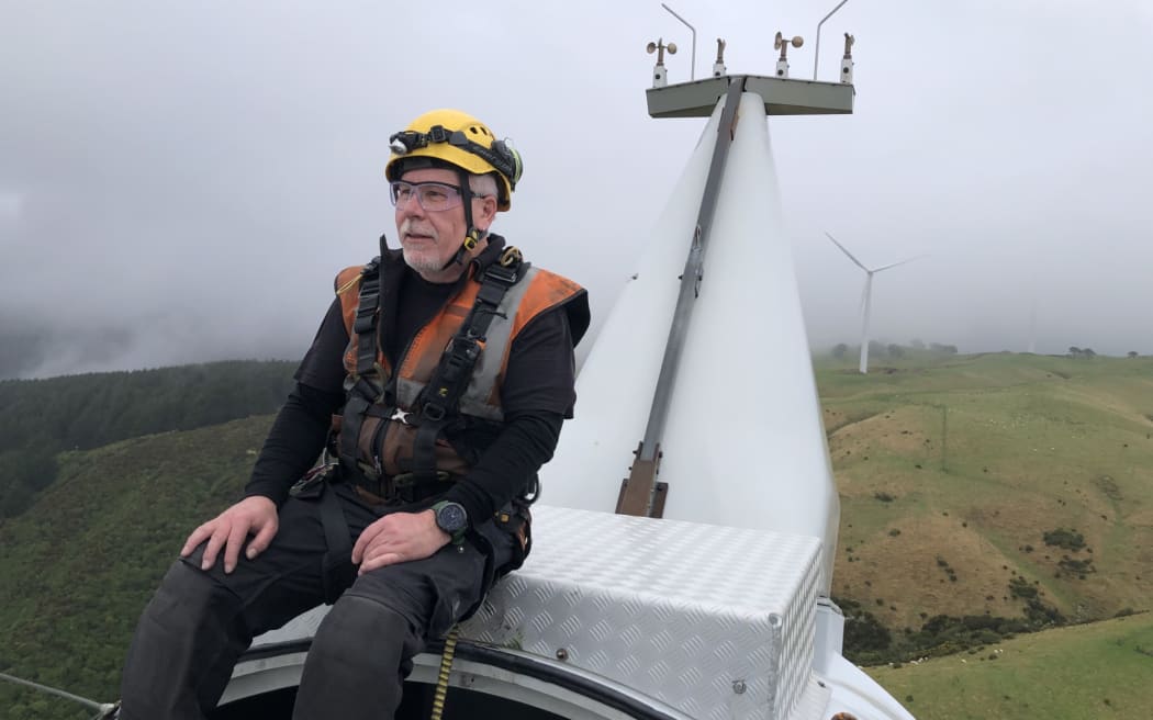 West Wind technician Tim Clark on top of a wind turbine at West Wind farm in Makara