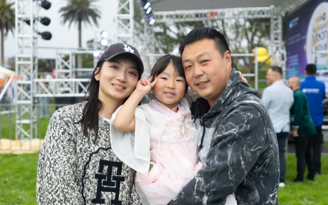Yanan Huo (right) sees the Auckland Moon Festival as a valuable opportunity for her 5-year-old daughter to experience traditional Chinese customs.