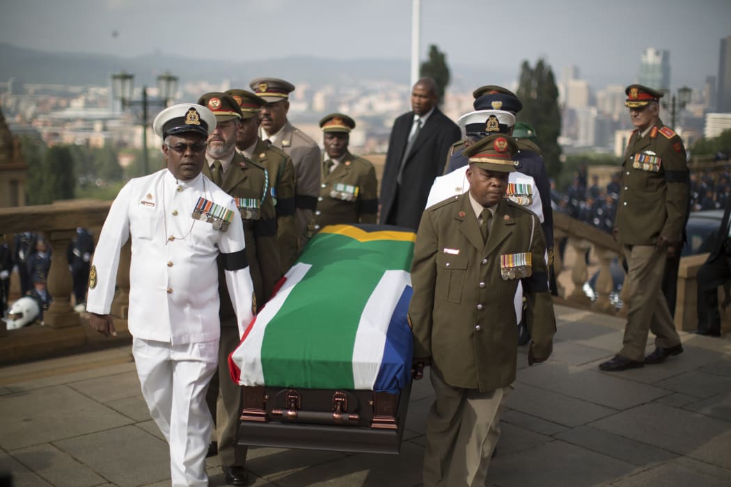 Military officers carry Nelson Mandela's coffin to the Union Buildings.