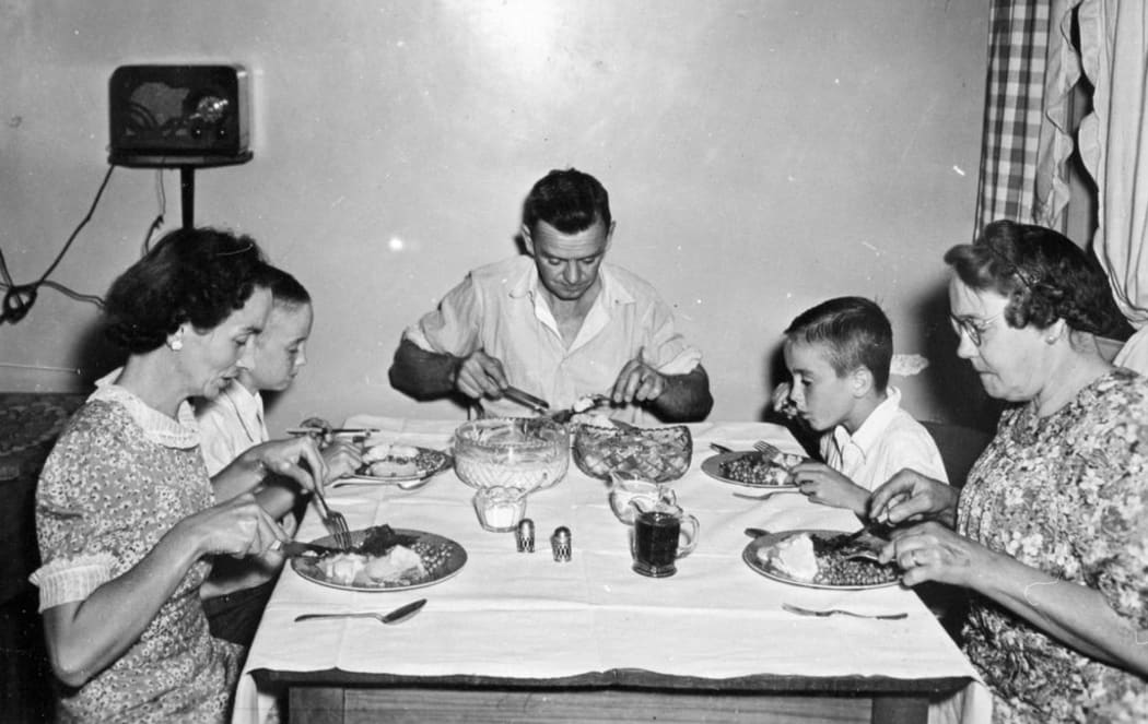 Evans family eating dinner, 1947.