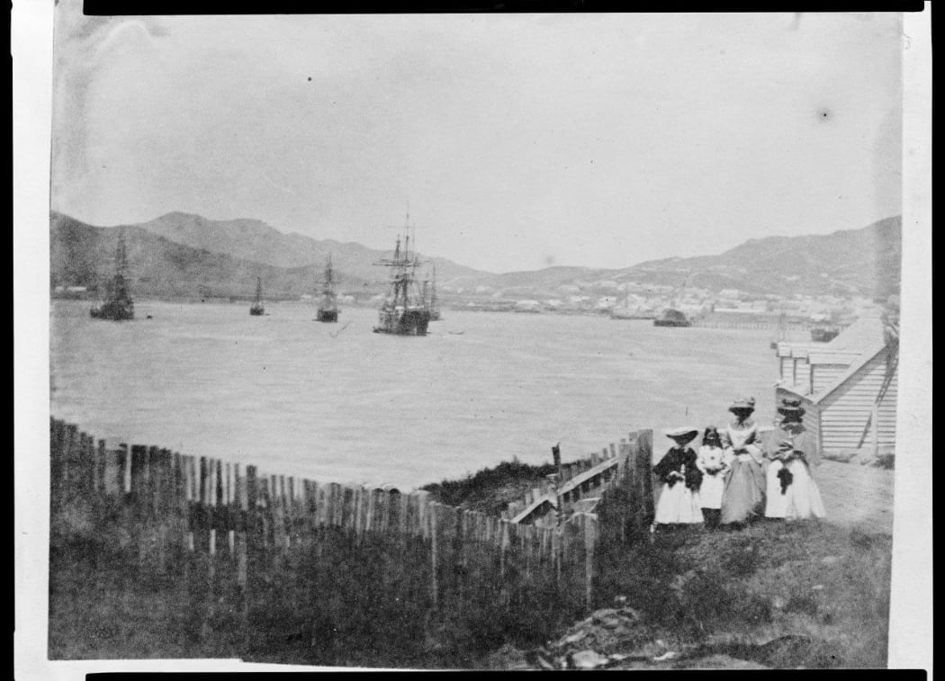 Looking South along Mulgrave Street towards the site of Wellington Railway Station, with a group of unidentified women and girls in the foreground.