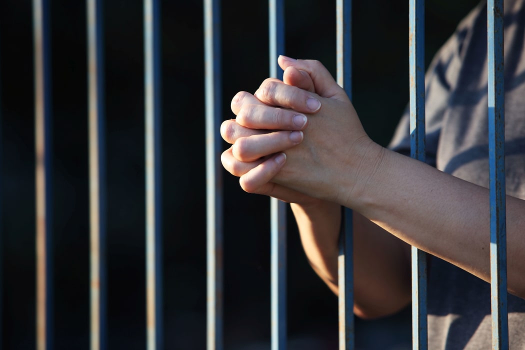 female hands in jail