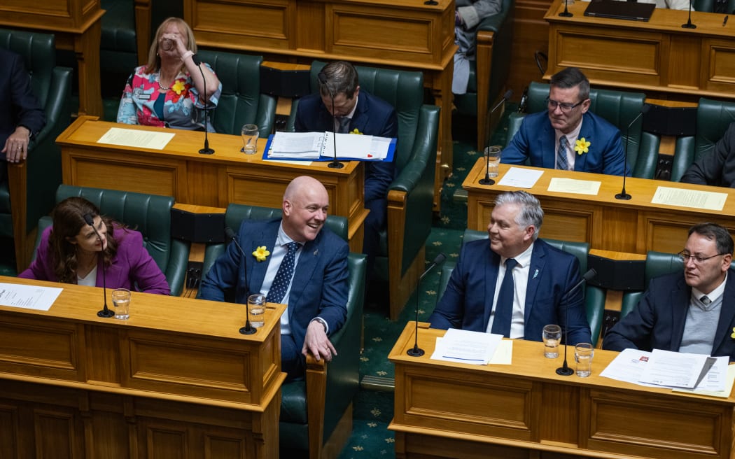 Christopher Luxon and Mark Mitchell find humour in Mitchell's 16th straight use of an identical question during Question Time.