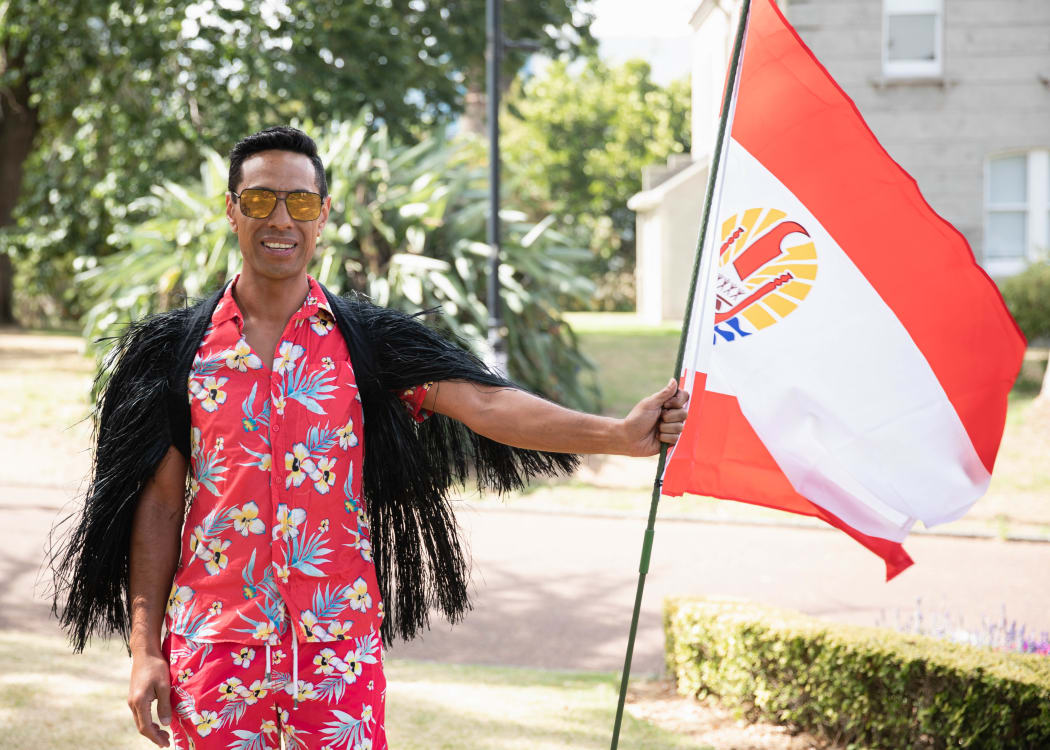 Henri Mason Katu with the flag of French Polynesia at OurMarch in Auckland.