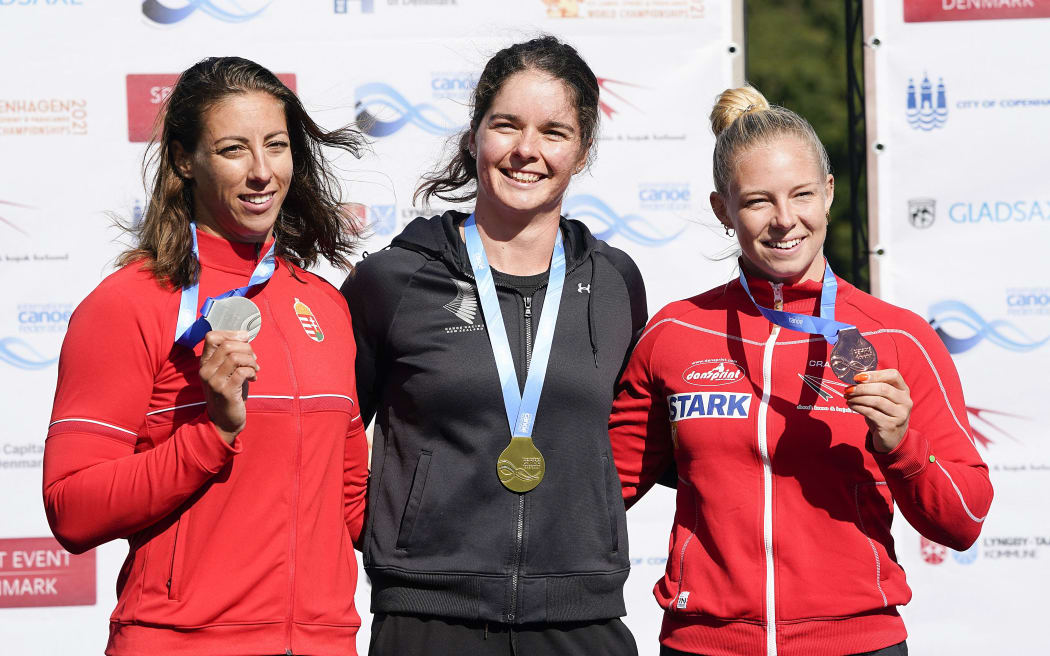 (L-r) Second placed Hungary's Tamara Csipes, winner New Zealand's Aimee Fisher and third placed Denmark's Emma Jorgensen celebrate on the podium after the women's K1 Kayak 500 m final of the Canoe and Kayak sprint Worlds Championsship 2021 in Copenhagen, Denmark, on September 19, 2021.