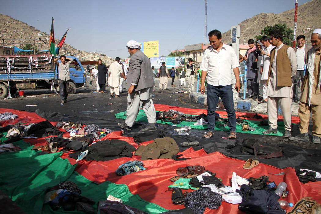 People examine the site where 80 people were killed and more than 200 wounded.