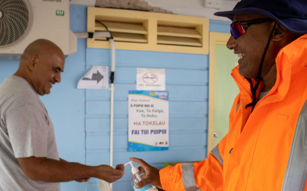 Tokelau Health Officer, Tenali and Dr Alani after unloading the truck of boxes HMNZS