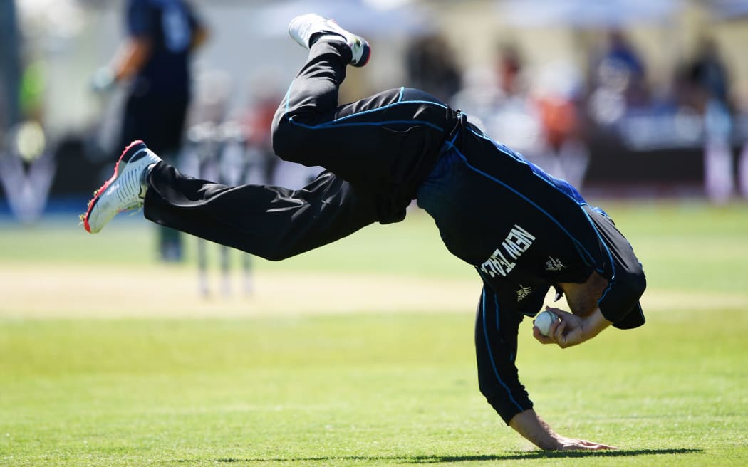 Brendon McCullum dives athletically to field a ball in the win over Scotland