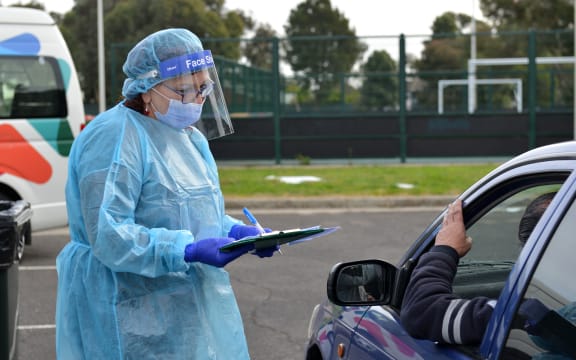 Health officials check people at a Covid-19 testing centre in Melbourne