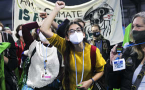 Climate activists and delegates stage a walk out in protest of the ongoing negotiations yesterday.