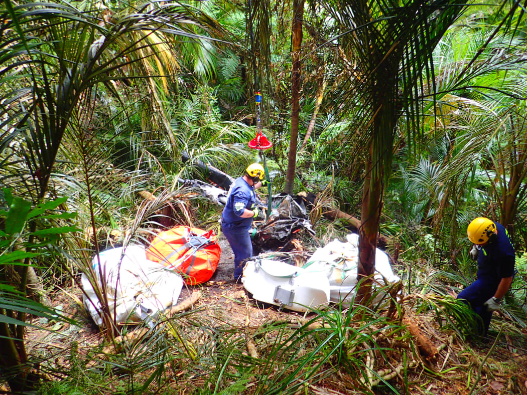 Investigators remove the wreckage of a Robinson R44 helicopter in Glenbervie forest near Whangarei.