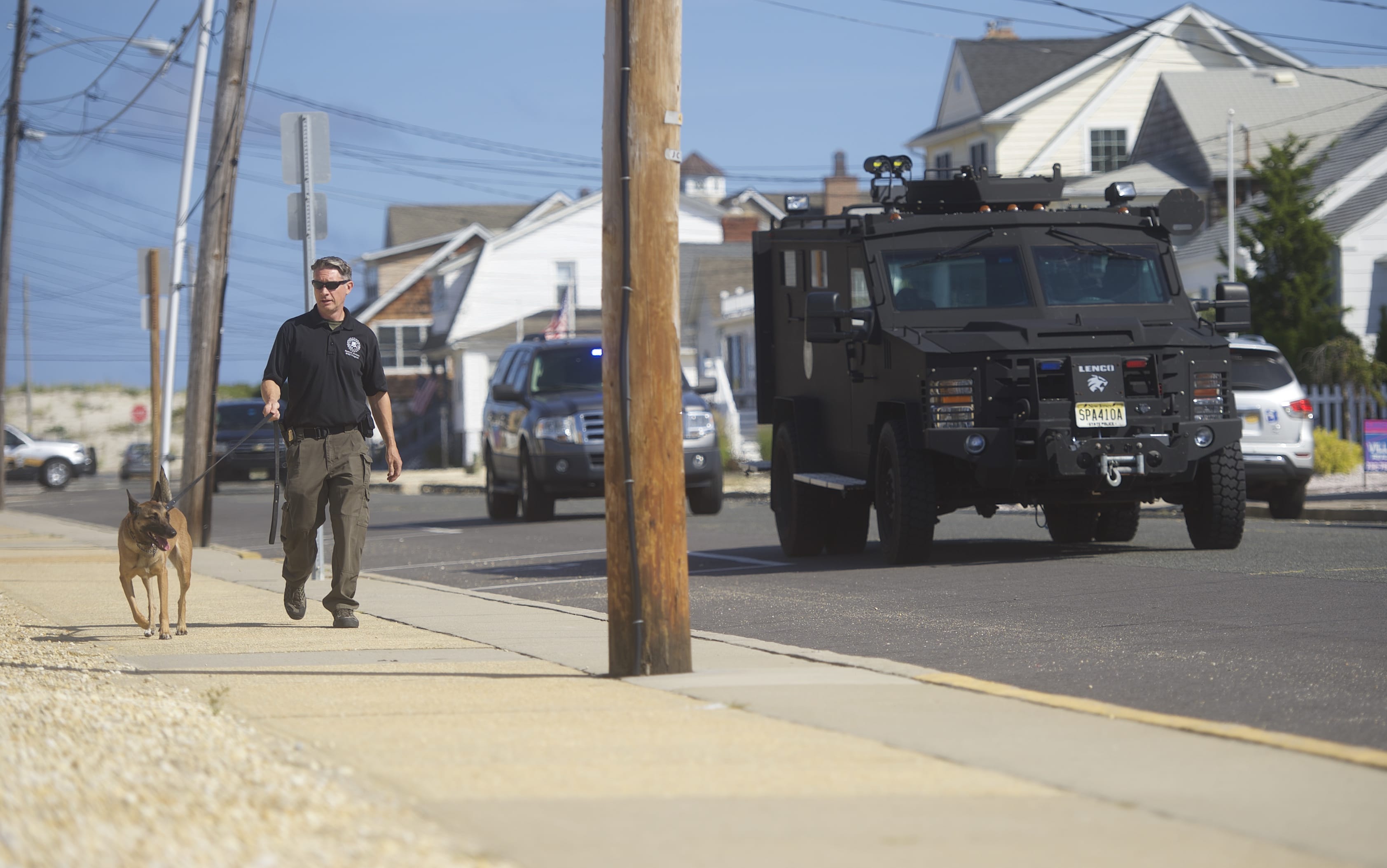 Police patrol near the site of a "pipe bomb-style device" explosion along a running race route in New Jersey.