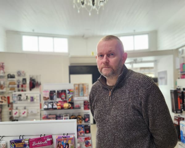 Ian Turner stands in his shop selling adult toys