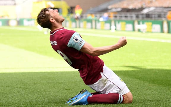 Burnley's New Zealand striker Chris Wood celebrates scoring his team's third goal during the English Premier League football match between Wolverhampton Wanderers and Burnley at the Molineux stadium in Wolverhampton, central England on April 25, 2021.