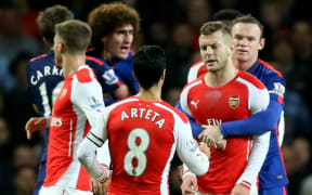 Manchester United and Arsenal players in a tussle